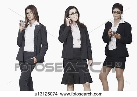 Three businesswomen using mobile phones View Large Photo Image Picture - Three businesswomen using mobile phones. Fotosearch