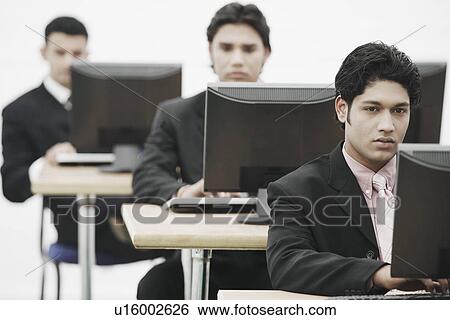 Stock Photograph - Businessman working on a computer. Fotosearch