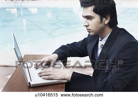 Stock Photography - Close-up of a businessman using a laptop. Fotosearch