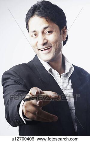 Stock Photograph - Portrait of a businessman holding a cigar. Fotosearch