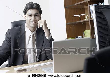 Stock Photography - Portrait of a businessman in an office. Fotosearch