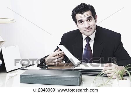 Stock Photo - Portrait of a businessman sitting in an office. Fotosearch