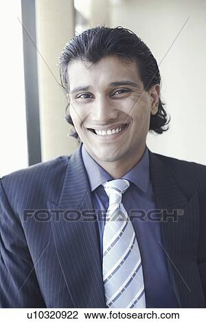 Portrait of a businessman smiling View Large Photo Image Stock Image - Portrait of a businessman smiling. Fotosearch