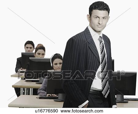 Portrait of a businessman standing in an office View Large Photo Image Stock Image - Portrait of a businessman standing in an office. Fotosearch