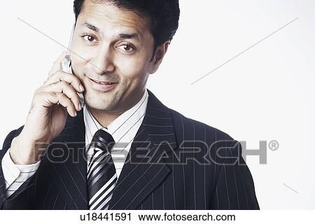 Portrait of a businessman talking on a mobile phone View Large Photo Image Stock Image - Portrait of a businessman talking on a mobile phone. Fotosearch