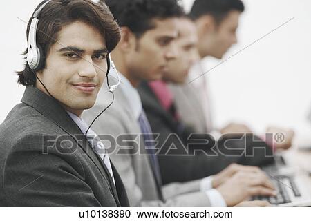 Stock Image - Portrait of a businessman wearing a headset. Fotosearch