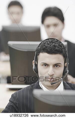 Stock Photograph - Portrait of a businessman wearing a headset. Fotosearch