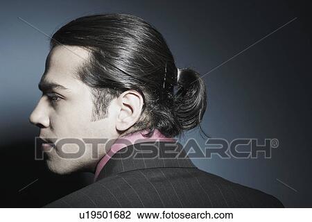 Rear view of a businessman looking sideways View Large Photo Image Stock Image - Rear view of a businessman looking sideways. Fotosearch