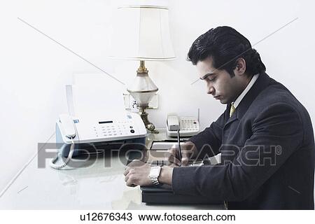 Side profile of a businessman working in an office View Large Photo Image Stock Image - Side profile of a businessman working in an office. Fotosearch