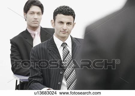 Picture - Two businessmen in an office. Fotosearch