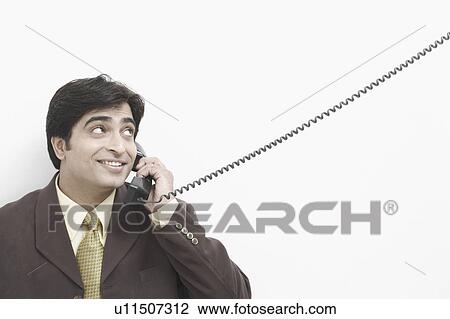 Stock Image - Businessman talking on the telephone. Fotosearch