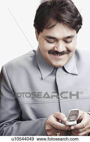Close-up of a businessman operating a mobile phone View Large Photo Image Stock Photo - Close-up of a businessman operating a mobile phone. Fotosearch
