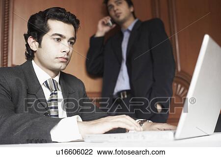 Close-up of a businessman using a laptop View Large Photo Image Stock Image - Close-up of a businessman using a laptop. Fotosearch