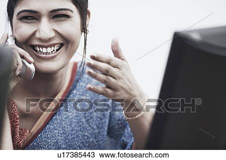 Close-up of a businesswoman talking on a mobile phone View Large Photo Image Stock Image - Close-up of a businesswoman talking on a mobile phone. Fotosearch