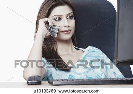 Stock Photo - Close-up of a businesswoman talking on a mobile phone. Fotosearch
