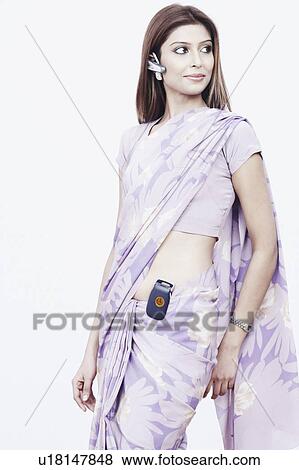 Close-up of a young woman wearing a hands free device View Large Photo Image Stock Photo - Close-up of a young woman wearing a hands free device. Fotosearch