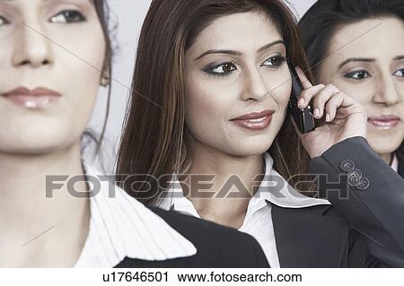 Close-up of three businesswomen looking away View Large Photo Image Stock Image - Close-up of three businesswomen looking away. Fotosearch