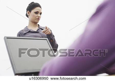 Discussion between two businesswomen View Large Photo Image Stock Image - Discussion between two businesswomen. Fotosearch