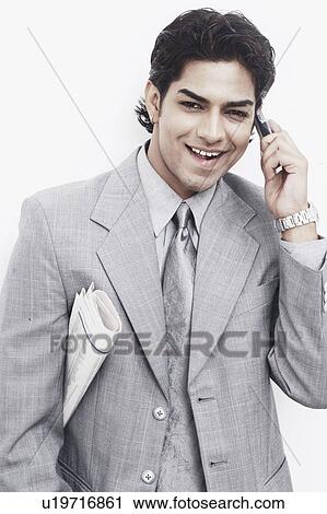 Portrait of a businessman talking on a mobile phone View Large Photo Image Stock Image - Portrait of a businessman talking on a mobile phone. Fotosearch