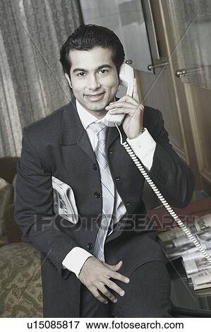 Stock Photo - Portrait of a businessman talking on the telephone. Fotosearch