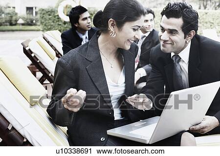 Close-up of a businesswoman and a businessman smiling View Large Photo Image Stock Image - Close-up of a businesswoman and a businessman smiling. Fotosearch