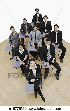 Stock Image - High angle view of business executives sitting on chairs. Fotosearch