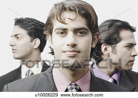 Stock Photo - Portrait of a businessman in front of two businessmen. Fotosearch