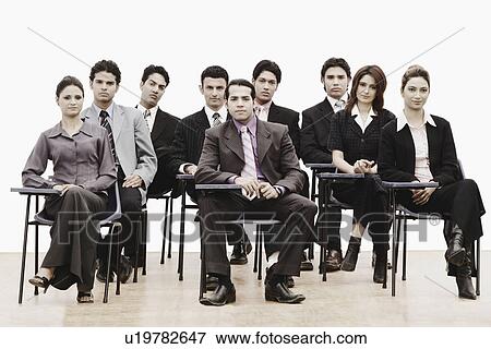 Stock Photo - Portrait of business executives sitting on chairs. Fotosearch
