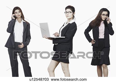 Portrait of two businesswomen talking on mobile phones with another businesswoman using a laptop View Large Photo Image Stock Image - Portrait of two businesswomen talking on mobile phones with another businesswoman using a laptop. Fotosearch