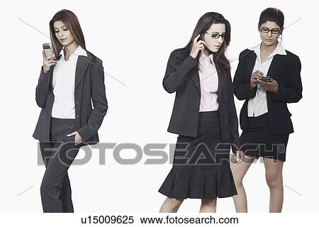 Stock Photography - Three businesswomen using mobile phones. Fotosearch