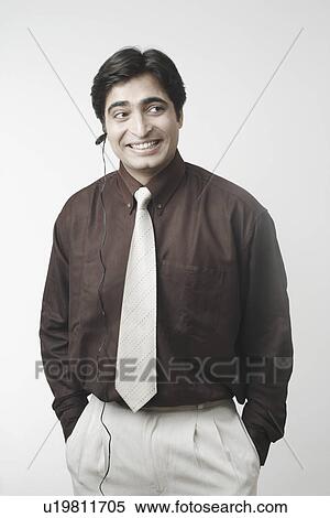 Stock Photography - Businessman using a hands free device. Fotosearch
