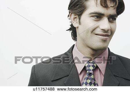 Close-up of a businessman smiling View Large Photo Image Stock Photo - Close-up of a businessman smiling. Fotosearch