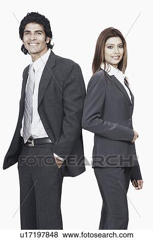 Portrait of a businessman and a businesswoman standing back to back View Large Photo Image Stock Photo - Portrait of a businessman and a businesswoman standing back to back. Fotosearch
