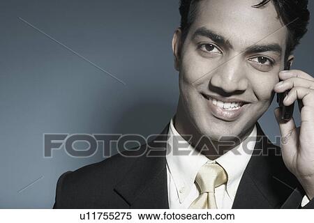 Portrait of a businessman holding a mobile phone View Large Photo Image Stock Photography - Portrait of a businessman holding a mobile phone. Fotosearch
