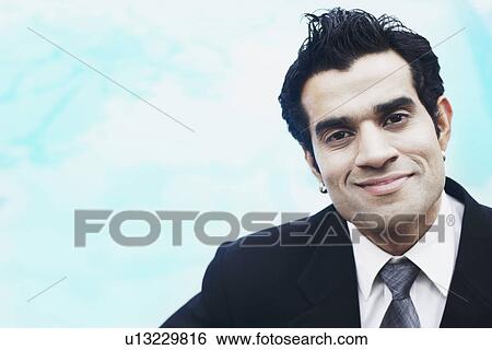 Portrait of a businessman smiling View Large Photo Image Stock Photograph - Portrait of a businessman smiling. Fotosearch
