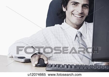 Stock Photography - Portrait of a businessman using a computer. Fotosearch