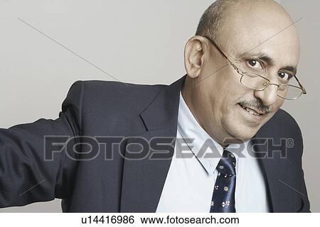 Portrait of a businessman wearing eyeglasses View Large Photo Image Stock Photograph - Portrait of a businessman wearing eyeglasses. Fotosearch