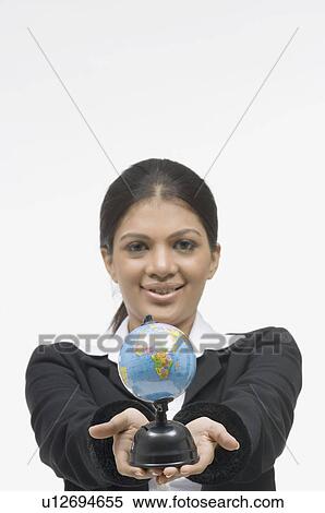 Stock Photography - Portrait of a businesswoman holding a globe. Fotosearch