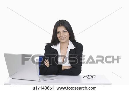 Stock Image - Portrait of a businesswoman sitting in front of a laptop. Fotosearch