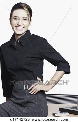 Portrait of a businesswoman sitting with her hand on her hip View Large Photo Image Stock Image - Portrait of a businesswoman sitting with her hand on her hip. Fotosearch
