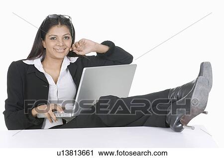Stock Image - Portrait of a businesswoman using a laptop. Fotosearch