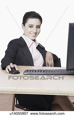 Stock Photo - Portrait of a businesswoman working on a computer. Fotosearch
