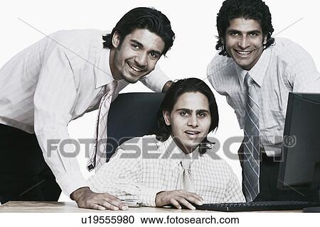 Stock Image - Portrait of three businessmen smiling. Fotosearch