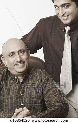 Portrait of two businessmen smiling View Large Photo Image Stock Image - Portrait of two businessmen smiling. Fotosearch