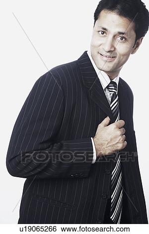 Stock Photograph - Side profile of a businessman smiling. Fotosearch