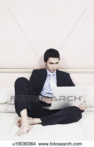 Picture - Businessman working on a laptop. Fotosearch
