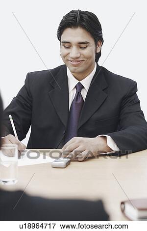 Stock Photo - Businessman writing on paper. Fotosearch