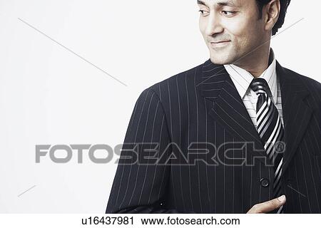 Close-up of a businessman looking sideways View Large Photo Image Stock Image - Close-up of a businessman looking sideways. Fotosearch