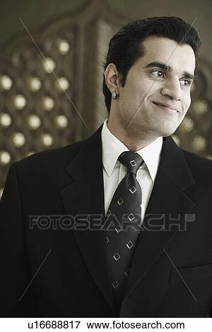 Close-up of a businessman smiling View Large Photo Image Stock Photo - Close-up of a businessman smiling. Fotosearch