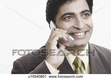 Close-up of a businessman talking on a mobile phone View Large Photo Image Stock Image - Close-up of a businessman talking on a mobile phone. Fotosearch